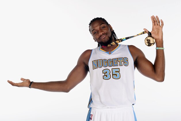DENVER, CO - SEPTEMBER 29: Kenneth Faried #35 of the Denver Nuggets poses with his gold medal from the 2014 FIBA World Cup of  Basketball during media day on September 29, 2014 at the Pepsi Center in Denver, Colorado. NOTE TO USER: User expressly acknowledges and agrees that, by downloading and/or using this Photograph, user is consenting to the terms and conditions of the Getty Images License Agreement. Mandatory Copyright Notice: Copyright 2014 NBAE (Photo by Garrett W. Ellwood/NBAE via Getty Images)