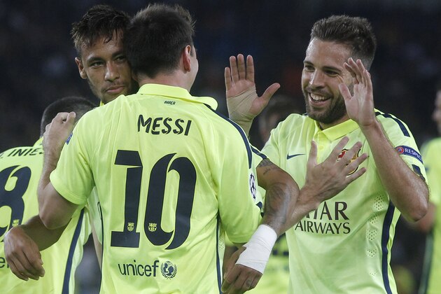 Barcelona's Lionel Messi, 10, is congratulated by teammates, Neymar, left, and Jordi Alba, right, during the Champions League Group F soccer match between Paris Saint German and Barcelona at Parc des Princes stadium in Paris, France, Tuesday, Sept. 30, 2014. (AP Photo/Michel Euler)