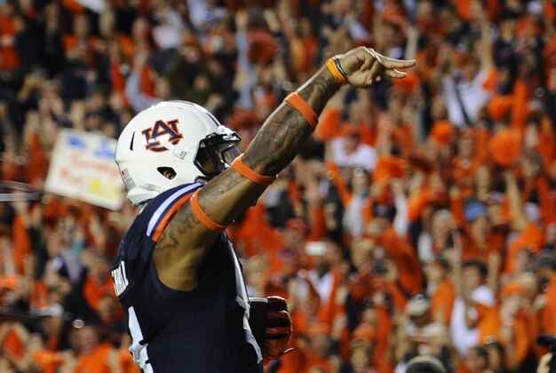 Oct 4, 2014; Auburn, AL, USA; Auburn Tigers quarterback Nick Marshall (14) runs a touchdown past LSU Tigers defense during the first quarter at Jordan Hare Stadium. Mandatory Credit: Shanna Lockwood-USA TODAY Sports