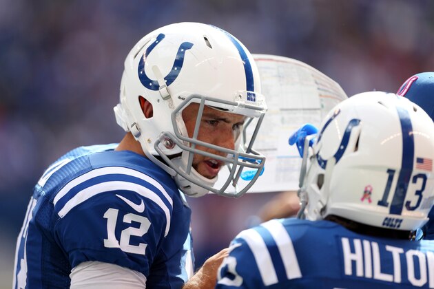 Oct 5, 2014; Indianapolis, IN, USA; Indianapolis Colts quarterback Andrew Luck (12) talks to wide receiver T.Y. Hilton (13) during a game against the Baltimore Ravens at Lucas Oil Stadium. Mandatory Credit: Brian Spurlock-USA TODAY Sports