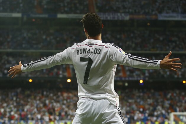 Real's Cristiano Ronaldo celebrates his third goal during a Spanish La Liga soccer match between Real Madrid and Athletic Bilbao at the Santiago Bernabeu stadium in Madrid, Spain, Sunday, Oct. 5, 2014. (AP Photo/Andres Kudacki)