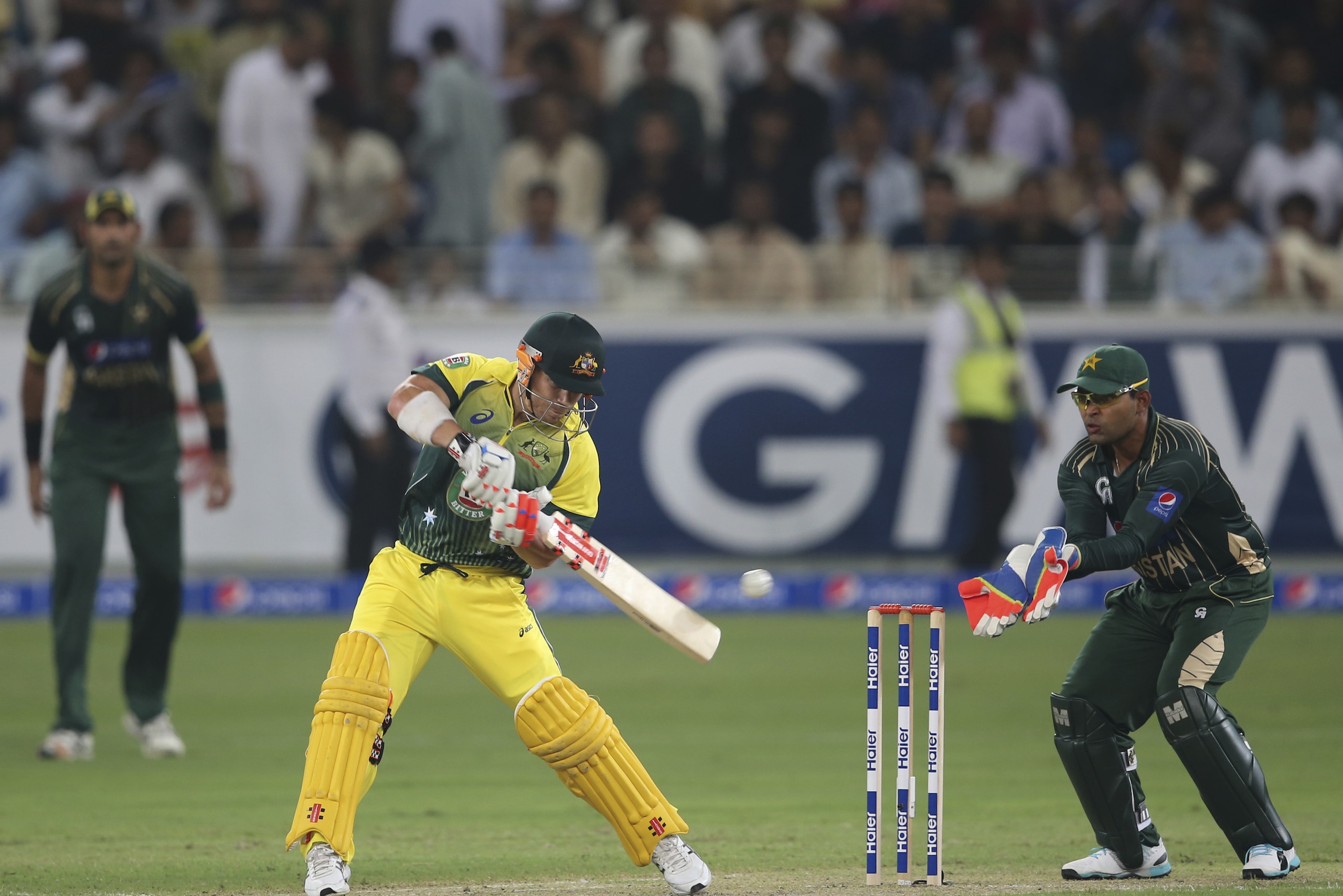 Australian batsman David Warner hits the ball during the first International T20 cricket match against Pakistan in Dubai, United Arab Emirates, Sunday, Oct. 5, 2014. (AP Photo/Kamran Jebreili)