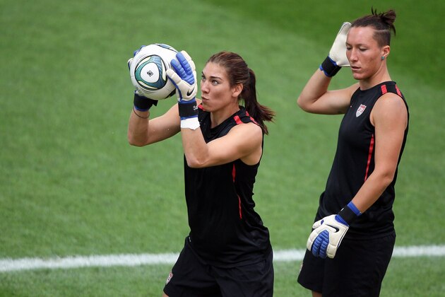 FRANKFURT AM MAIN, GERMANY - JULY 16:  Hope Solo of USA (L) saves a ball and  Jill Loyden watche sher (R) during the USA team training session at FIFA World Cup Stadium Frankfurt on July 16, 2011 in Frankfurt am Main, Germany.  (Photo by Christof Koepsel/Getty Images)