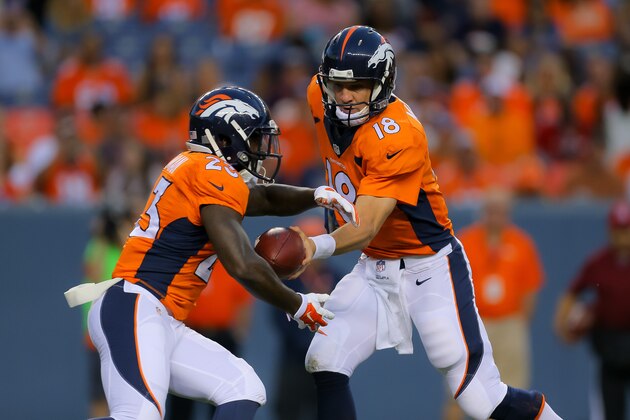 DENVER, CO - AUGUST 23:  Quarterback Peyton Manning #18 of the Denver Broncos hands off to running back Ronnie Hillman #23 during a preseason game at Sports Authority Field at Mile High on August 23, 2014 in Denver, Colorado.  (Photo by Justin Edmonds/Getty Images)