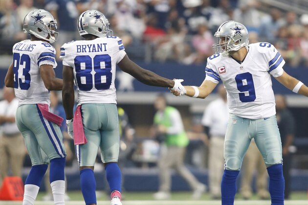 Oct 5, 2014; Arlington, TX, USA; Dallas Cowboys quarterback Tony Romo (9) congratulates Dallas Cowboys wide receiver Dez Bryant (88) after making a catch in overtime as Dallas Cowboys wide receiver Terrance Williams (83) looks on in the game against the Houston Texans at AT&T Stadium. Dallas beat Houston 20-17 in overtime. Mandatory Credit: Tim Heitman-USA TODAY Sports