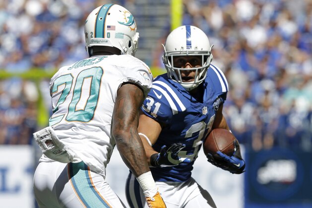 Indianapolis Colts' Donald Brown (31) runs against Miami Dolphins' Reshad Jones (20) during the first half an NFL football game Sunday, Sept. 15, 2013, in Indianapolis. (AP Photo/Michael Conroy)
