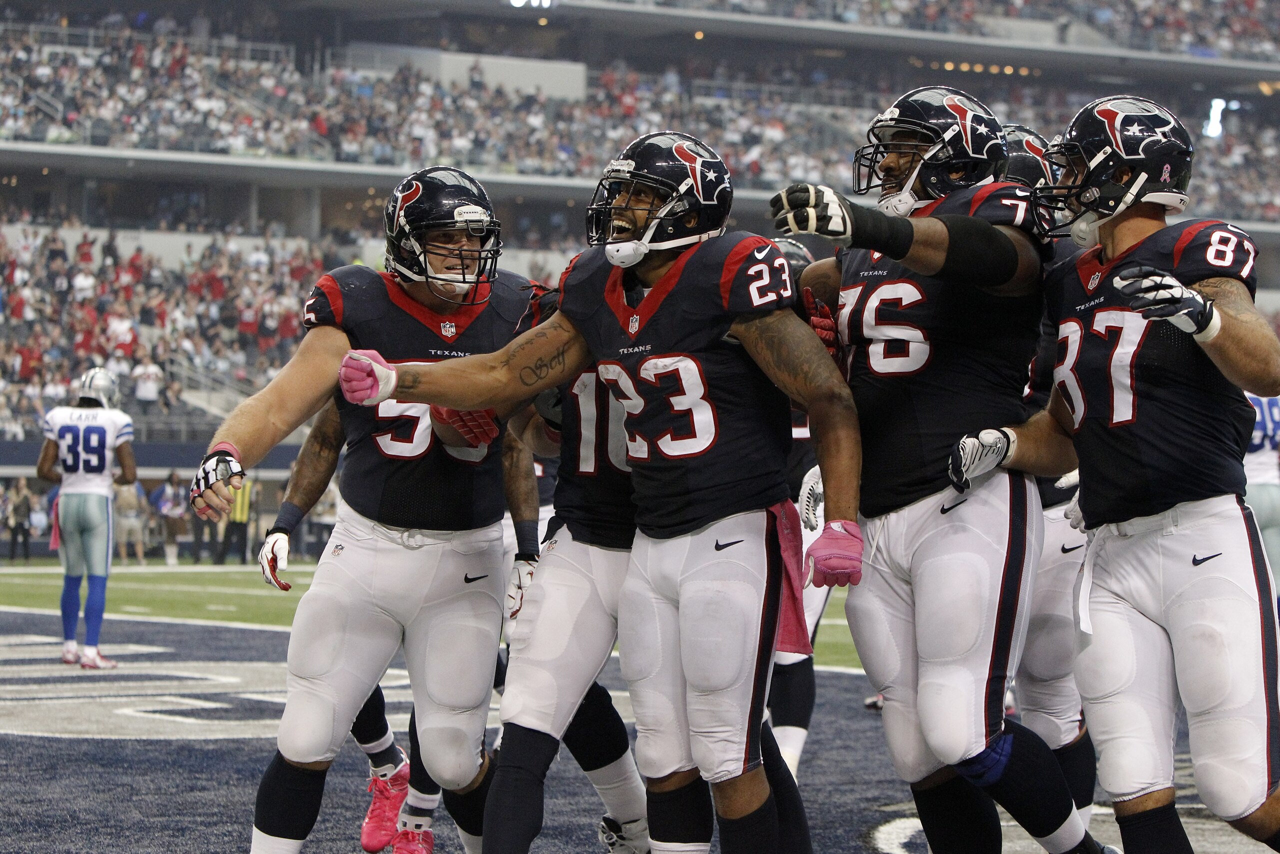 Houston Texans' Chris Myers (55), Duane Brown (76) and C.J. Fiedorowicz (87) celebrate with Arian Foster (23) following Foster's touchdown run against the Dallas Cowboys during the second half of an NFL football game, Sunday, Oct. 5, 2014, in Arlington, Texas. (AP Photo/Brandon Wade)