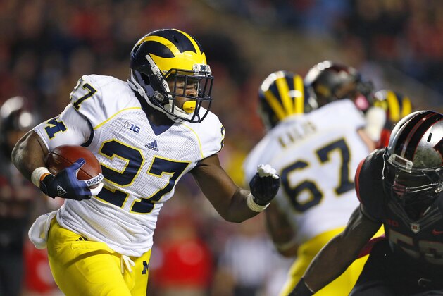 Michigan running back Derrick Green (27) is pursued by Rutgers' Quentin Gause during the second half of an NCAA college football game Saturday, Oct. 4, 2014, in Piscataway, N.J. Rutgers defeated Michigan 26-24. (AP Photo/Rich Schultz)