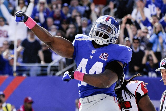 New York Giants running back Andre Williams (44) celebrates after scoring on a touchdown run against the Atlanta Falcons during the second half of an NFL football game, Sunday, Oct. 5, 2014, in East Rutherford, N.J. (AP Photo/Bill Kostroun)