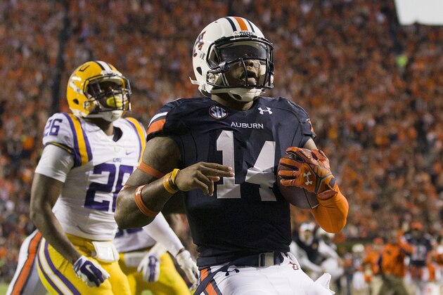 Auburn quarterback Nick Marshall (14) runs in for a touchdown against LSU in the first half of an NCAA college football game on Saturday, Oct. 4, 2014, in Auburn, Ala. (AP Photo/Brynn Anderson)