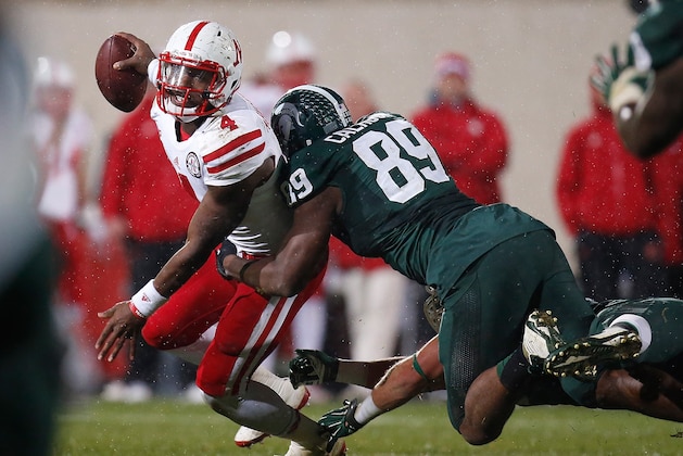 EAST LANSING, MI - OCTOBER 04:  Tommy Armstrong Jr. #4 of the Nebraska Cornhuskers is sacked in the the third quarter by Shilique Calhoun #89 of the Michigan State Spartans at Spartan Stadium on October 4, 2014 in East Lansing, Michigan. (Photo by Gregory Shamus/Getty Images)