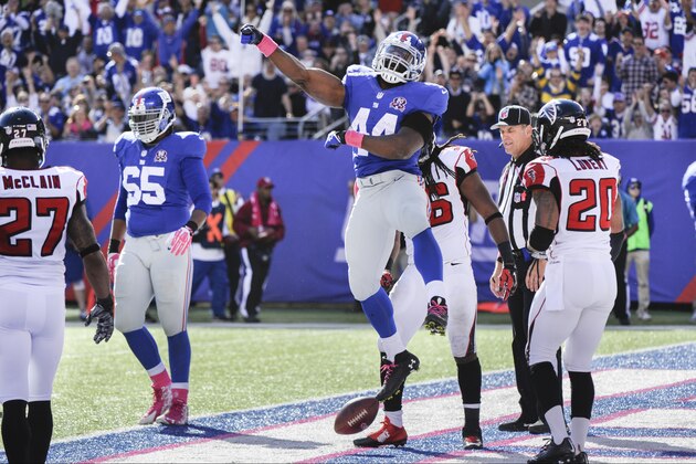 New York Giants running back Andre Williams celebrates after scoring on a touchdown run against the Atlanta Falcons during the second half of an NFL football game, Sunday, Oct. 5, 2014, in East Rutherford, N.J. (AP Photo/Bill Kostroun)