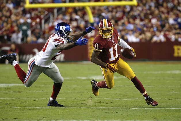 New York Giants cornerback Prince Amukamara (20) closes in on Washington Redskins wide receiver DeSean Jackson (11) during the first half of an NFL Thursday night football game in Landover, Md., Thursday, Sept. 25, 2014. (AP Photo/Alex Brandon)