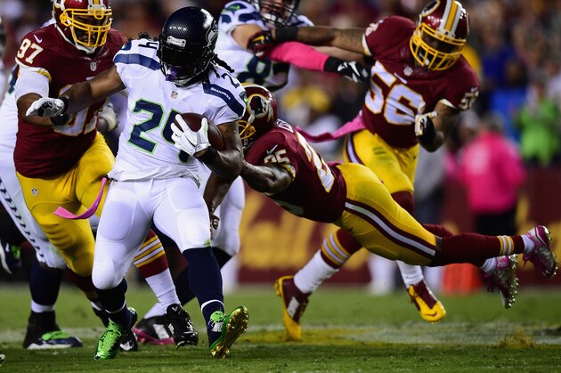 LANDOVER, MD - OCTOBER 06: Running back Marshawn Lynch #24 of the Seattle Seahawks is tackled by free safety Ryan Clark #25 of the Washington Redskins in the first half of a game at FedExField on October 6, 2014 in Landover, Maryland.  (Photo by Patrick Smith/Getty Images)