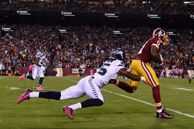 LANDOVER, MD - OCTOBER 06: Wide receiver DeSean Jackson #11 of the Washington Redskins sheds the tackle of cornerback Richard Sherman #25 of the Seattle Seahawks for a second quarter touchdown at FedExField on October 6, 2014 in Landover, Maryland.  (Photo by Patrick Smith/Getty Images)