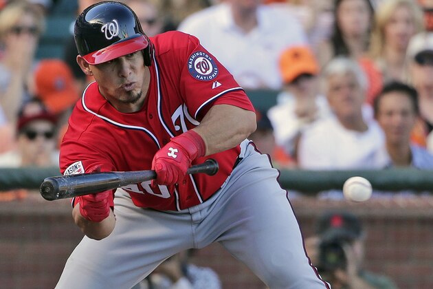 Washington Nationals Wilson Ramos bunts in the seventh inning against the San Francisco Giants during Game 3 of baseball's NL Division Series in San Francisco, Monday, Oct. 6, 2014. San Francisco Giants pitcher Madison Bumgarner had a throwing error on this play that scored two runs for the Nationals. (AP Photo/Marcio Jose Sanchez)