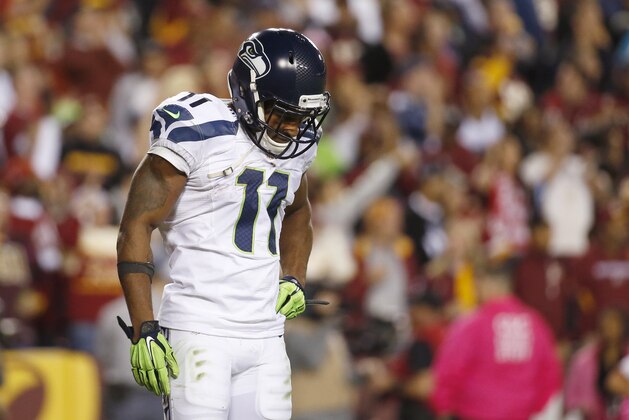 Seattle Seahawks wide receiver Percy Harvin (11) looks down and shakes his head after his touchdown was called back for a penalty during the second half of an NFL football game against the Washington Redskins in Landover, Md., Monday, Oct. 6, 2014. (AP Photo/Alex Brandon)