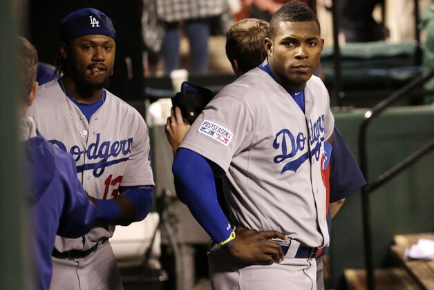 Los Angeles Dodgers' Yasiel Puig, right, and Hanley Ramirez stand in the dugout at the end of Game 3 of baseball's NL Division Series against the St. Louis Cardinals, Monday, Oct. 6, 2014, in St. Louis. The Cardinals won 3-1. (AP Photo/Charles Rex Arbogast)