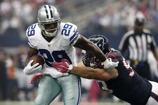 Dallas Cowboys' DeMarco Murray (29) attempts to escape a tackle by Houston Texans defensive end Jared Crick (93) during the first half of an NFL football game, Sunday, Oct. 5, 2014, in Arlington, Texas. (AP Photo/Brandon Wade)