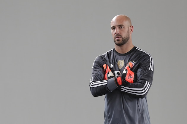 Bayern Munich's goalkeeper Pepe Reina of Spain waits for an official photo shooting for the new German first division Bundesliga season in Munich, southern Germany, Saturday, Aug. 9, 2014. (AP Photo/Matthias Schrader)