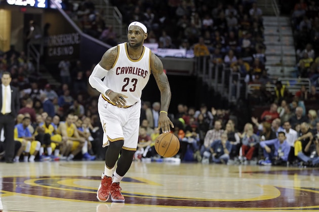 Cleveland Cavaliers' LeBron James (23) brings the ball up against Maccabi Tel Aviv in the second quarter of a preseason exhibition basketball game Sunday, Oct. 5, 2014, in Cleveland. (AP Photo/Mark Duncan)