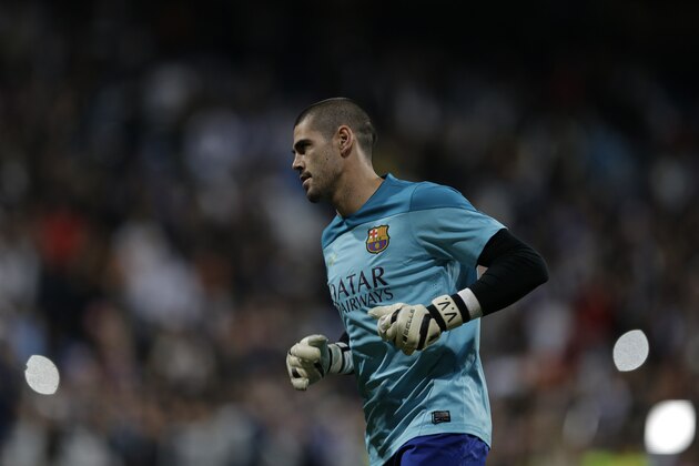 FC Barcelona's goalkeeper Victor Valdes warms up before a Spanish La Liga soccer match against Real Madrid at the Santiago Bernabeu stadium in Madrid, Sunday March 23, 2014. (AP Photo/Paul White)