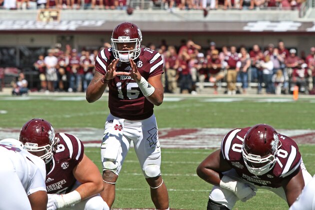 Mississippi State quarterback Dak Prescott (15) gets set to receive the ball from center Jamaal Clayborn (60) as Justin Malone (70) is ready for the play during the first half of their NCAA college football game with Texas A&M in Starkville, Miss., Saturday, Oct. 4, 2014.Miss. St. won 48-31. (AP Photo/Jim Lytle)