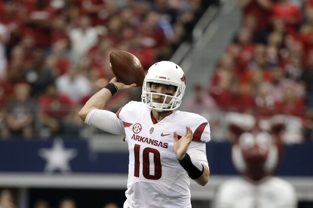 Arkansas quarterback Brandon Allen (10) passes after scrambling out of the pocket during an NCAA college football game against Texas A&M, Saturday, Sept. 27, 2014, in Arlington, Texas. (AP Photo/Tony Gutierrez)