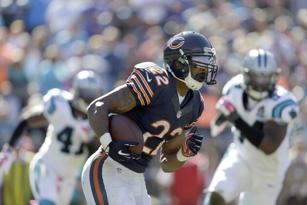 Chicago Bears' Matt Forte (22) looks for some running room against the Carolina Panthers during the second half of an NFL football game in Charlotte, N.C., Sunday, Oct. 5, 2014. The Panthers won 31-24. (AP Photo/Bob Leverone)