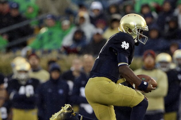 Notre Dame quarterback Everett Golson, right, runs out of the tackle of Stanford defensive end Henry Anderson (91) during the second half of an NCAA college football game Saturday, Oct. 4, 2014, in South Bend, Ind. Notre Dame defeated Stanford 17-14. (AP Photo/Darron Cummings)