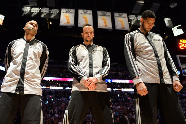 SAN ANTONIO, TX - JUNE 15: Tony Parker #9, Manu Ginobili #20 and Tim Duncan #21 of the San Antonio Spurs stand in observance of the national anthem before Game Five of the 2014 NBA Finals between the Miami Heat and San Antonio Spurs at AT&T Center on June 15, 2014 in San Antonio, Texas. NOTE TO USER: User expressly acknowledges and agrees that, by downloading and/or using this photograph, user is consenting to the terms and conditions of the Getty Images License Agreement.  Mandatory Copyright Notice: Copyright 2014 NBAE (Photo by Andrew D Bernstein/NBAE via Getty Images)