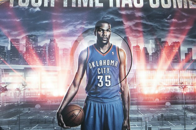 In this photo taken Tuesday, Sept. 16, 2014, 2K Sports Vice President Sports Development, Jeffrey Thomas, poses for a photo with his company's NBA 2K15 video game technology featuring NBA Oklahoma City Thunder Kevin Durant, during a demonstration at the Associated Press's office in Los Angeles. The NBA 2k15 upcoming basketball simulation video game developed by Visual Concepts and published by 2K Sports  releases Oct. 7, 2014. (AP Photo/Damian Dovarganes)