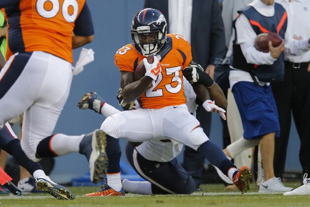 Denver Broncos running back Ronnie Hillman is tackled againt the Houston Texans during the first half of an NFL preseason football game, Saturday, Aug. 23, 2014, in Denver. (AP Photo/Jack Dempsey)