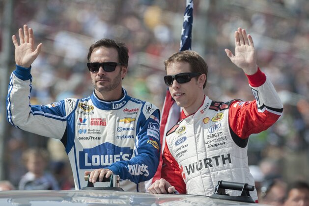 Mar 23, 2014; Fontana, CA, USA; NASCAR Sprint Cup Series driver Jimmie Johnson (48) and driver Brad Keselowski (2) wave to fans before the Auto Club 400 at Auto Club Speedway. Mandatory Credit: Ed Szczepanski-USA TODAY Sports