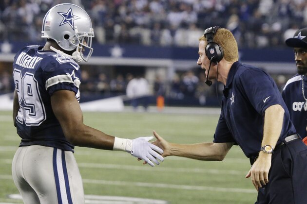 Dallas Cowboys head coach Jason Garrett congratulates DeMarco Murray (29) after Murray scored a touchdown against the Oakland Raiders during the second half of an NFL football game, Thursday, Nov. 28, 2013, in Arlington, Texas.  (AP Photo/LM Otero)