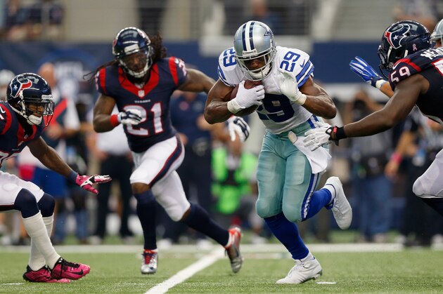 ARLINGTON, TX - OCTOBER 05:   DeMarco Murray #29 of the Dallas Cowboys carries the ball against  Kendrick Lewis #21 of the Houston Texans and  Whitney Mercilus #59 of the Houston Texans in overtime at AT&T Stadium on October 5, 2014 in Arlington, Texas.  (Photo by Tom Pennington/Getty Images)