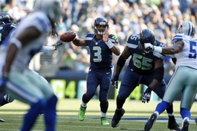 Seattle Seahawks quarterback Russell Wilson, center, looks to pass in the second half of an NFL football game against the Dallas Cowboys, Sunday, Sept. 16, 2012, in Seattle. (AP Photo/Kevin P. Casey)