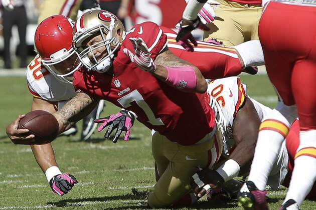 San Francisco 49ers quarterback Colin Kaepernick (7) is tackled by Kansas City Chiefs inside linebacker Josh Mauga (90) and outside linebacker Justin Houston, rear, during the first quarter of an NFL football game in Santa Clara, Calif., Sunday, Oct. 5, 2014. (AP Photo/Marcio Jose Sanchez)
