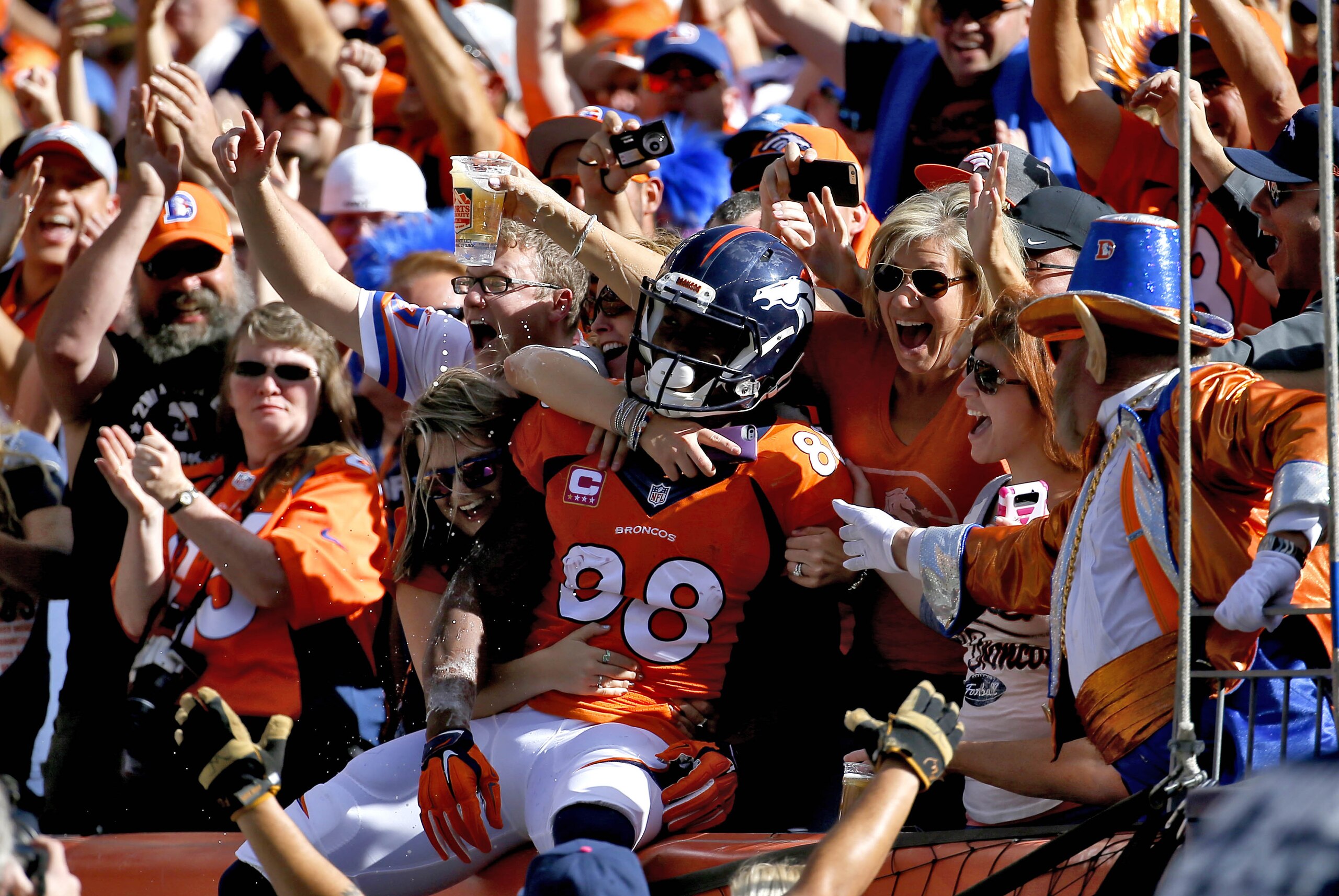 Denver Broncos wide receiver Demaryius Thomas (88) celebreats his touchdown with fans against the Arizona Cardinals during the first half of an NFL football game, Sunday, Oct. 5, 2014, in Denver. (AP Photo/Jack Dempsey)