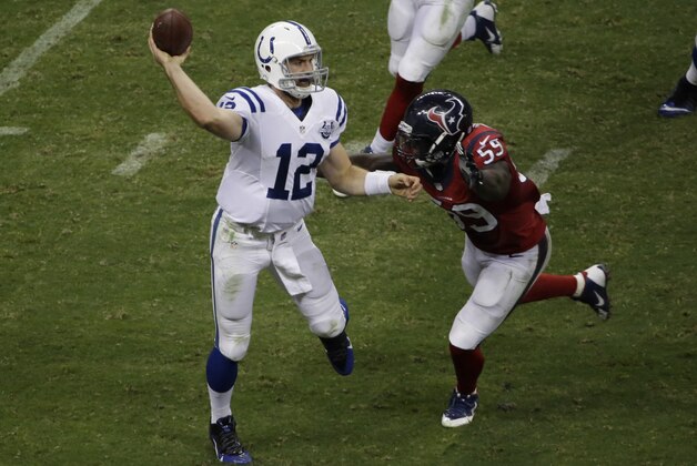 Indianapolis Colts' Andrew Luck (12) passes as Houston Texans' Whitney Mercilus (59) pressures him during the second quarter of an NFL football game, Sunday, Nov. 3, 2013, in Houston. (AP Photo/Pat Sullivan)