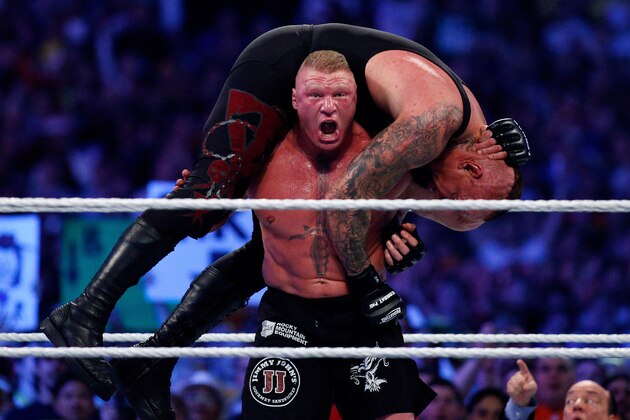 The Undertake, top, and Brock Lesnar, bottom, compete during Wrestlemania XXX at the Mercedes-Benz Super Dome in New Orleans on Sunday, April 6, 2014. (Jonathan Bachman/AP Images for WWE)