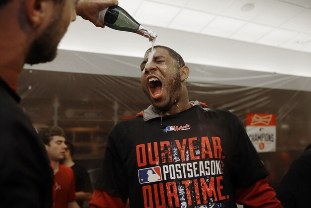 St. Louis Cardinals right fielder Oscar Taveras celebrates in the locker room with teammates after their 3-2 win over the Los Angeles Dodgers in Game 4 of baseball's NL Division Series, Tuesday, Oct. 7, 2014, in St. Louis. (AP Photo/Jeff Roberson)