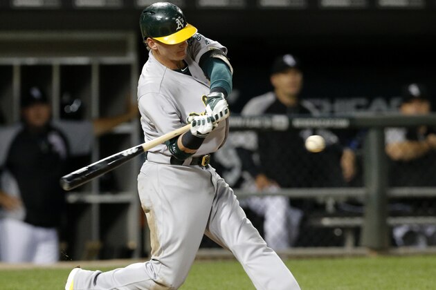 Oakland Athletics' Josh Donaldson hits a two-run double off Chicago White Sox starting pitcher John Danks, scoring Coco Crisp and pinch runner Josh Reddick, during the fifth inning of a baseball game Tuesday, Sept. 9, 2014, in Chicago. (AP Photo/Charles Rex Arbogast)