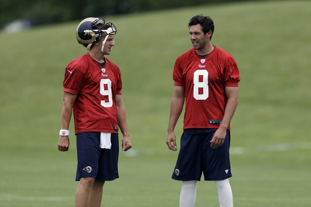St. Louis Rams quarterbacks Sam Bradford, right, and Austin Davis talk during an organized team activity at the NFL football team's practice facility Thursday, June 5, 2014, in St. Louis. (AP Photo/Jeff Roberson)