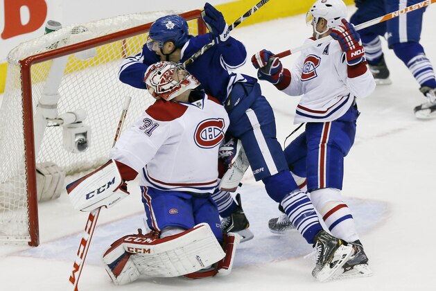 Mar 22, 2014; Toronto, Ontario, CAN; Toronto Maple Leafs forward James van Riemsdyk (21) collides with Montreal Canadiens goaltender Carey Price (31) as defenseman Andrei Markov (79) looks on during the third period at the Air Canada Centre. Montreal defeated Toronto 4-3. Mandatory Credit: John E. Sokolowski-USA TODAY Sports