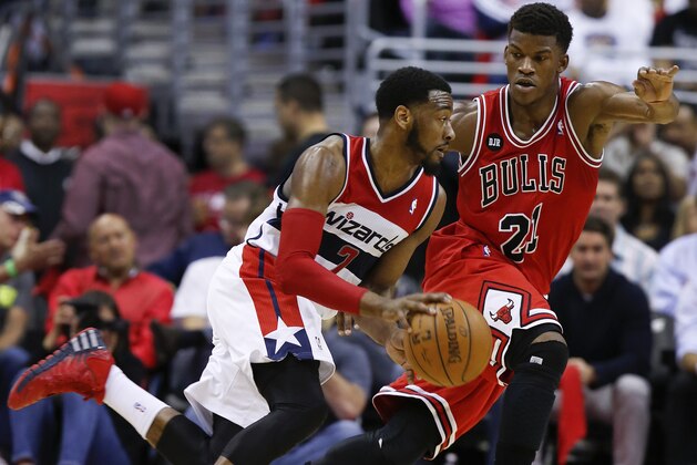 Washington Wizards forward Al Harrington (7) drives past Chicago Bulls guard Jimmy Butler (21) during the first half of Game 4 of an opening-round NBA basketball playoff series in Washington, Sunday, April 27, 2014. (AP Photo/Alex Brandon)
