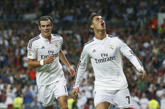 Real's Cristiano Ronaldo, right, celebrates  his goal with Real's Gareth Bale, left, during a Spanish La Liga soccer match between Real Madrid and Elche at the Santiago Bernabeu stadium in Madrid, Spain, Tuesday, Sept. 23, 2014. (AP Photo/Andres Kudacki)