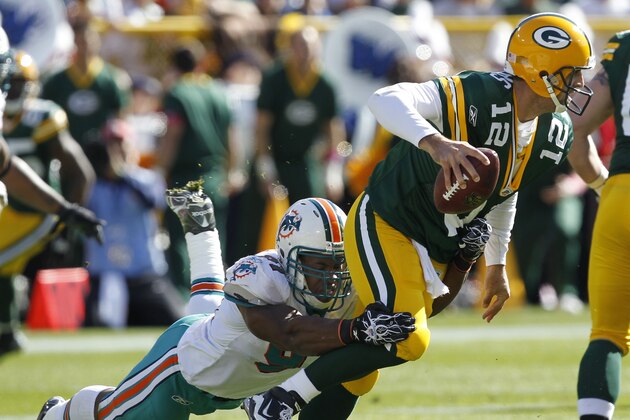 Miami Dolphins linebacker Cameron Wake, left, sacks Green Bay Packers quarterback Aaron Rodgers (12) during the first half of an NFL football game Sunday, Oct. 17, 2010, in Green Bay, Wis. (AP Photo/Mike Roemer)