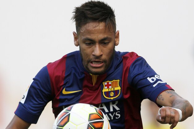 Barcelona's Neymar controls the ball during a Spanish La Liga soccer match between Rayo Vallecano and FC Barcelona at the Vallecas stadium in Madrid, Spain, Saturday, Oct. 4, 2014. (AP Photo/Andres Kudacki)