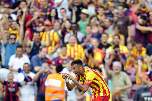 FC Barcelona's Neymar, from Brazil, celebrates scoring during a Spanish La Liga soccer match between FC Barcelona and Athletic Bilbao at the Camp Nou stadium in Barcelona, Spain, Saturday, Sept. 13, 2014. (AP Photo/Manu Fernandez)